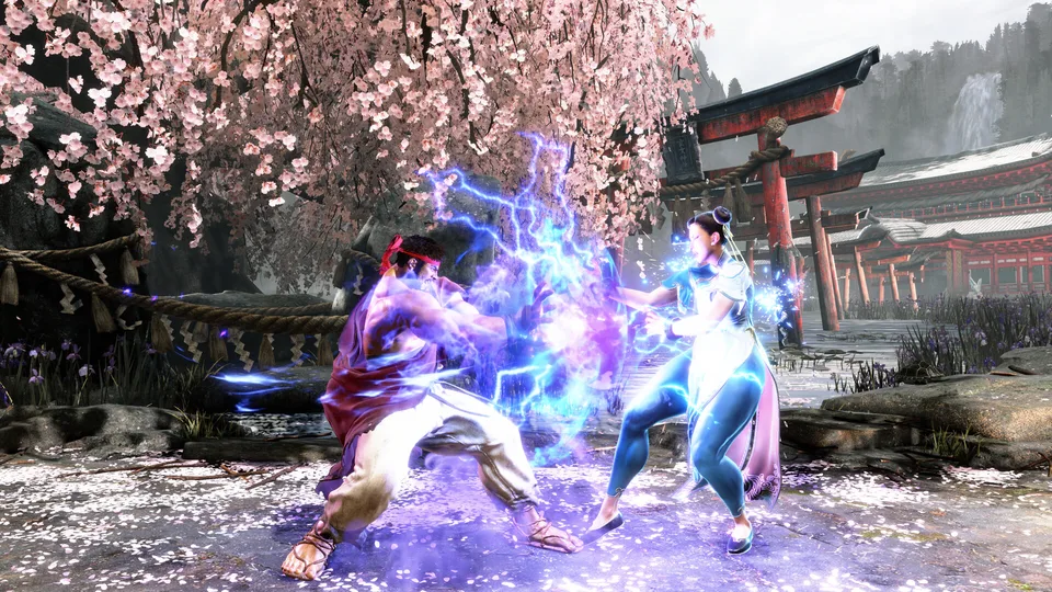 Two fighters trading blows on a blossom-lined Street Fighter 6 stage